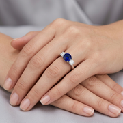 Round Blue Sapphire Three Stone Ring in 10K/14K gold and platinum with certified lab-grown or natural diamonds