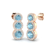 Graduated Aquamarine Halo Stud Earrings in 10K/14K gold and platinum with certified lab-grown or natural diamonds