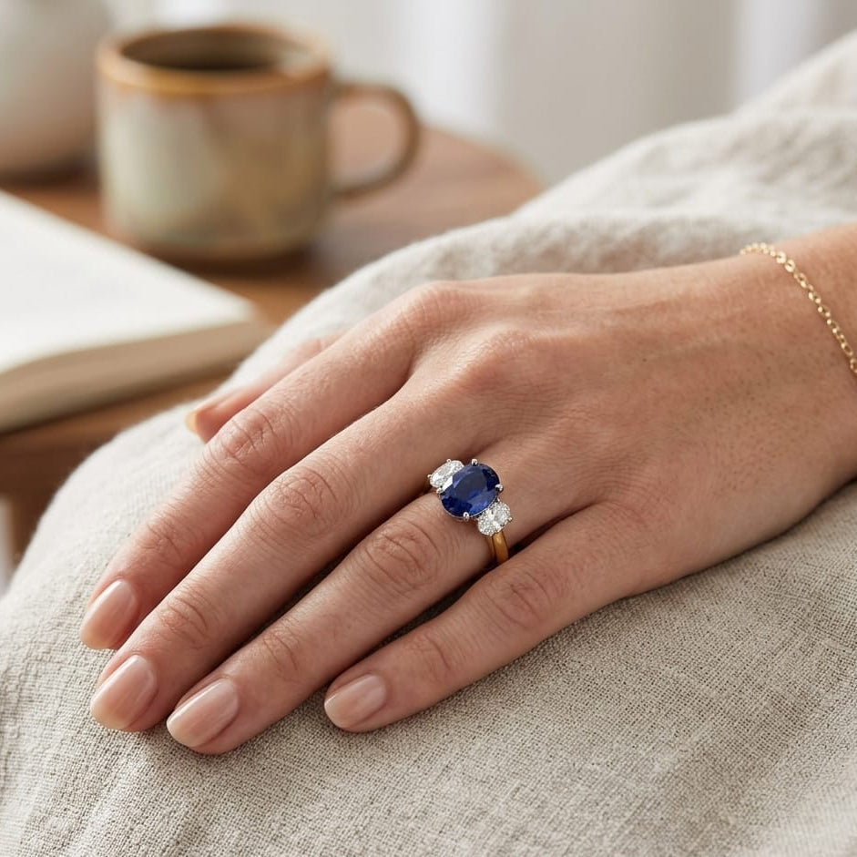 Natural Oval Cut Blue Sapphire with Side Stone Ring in Prong Set in 10K/14K gold and platinum with certified lab-grown or natural diamonds